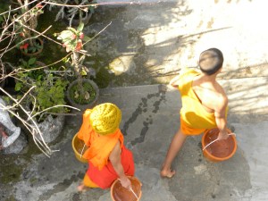 Novice monks doing chores at monastery - Luang Prabang